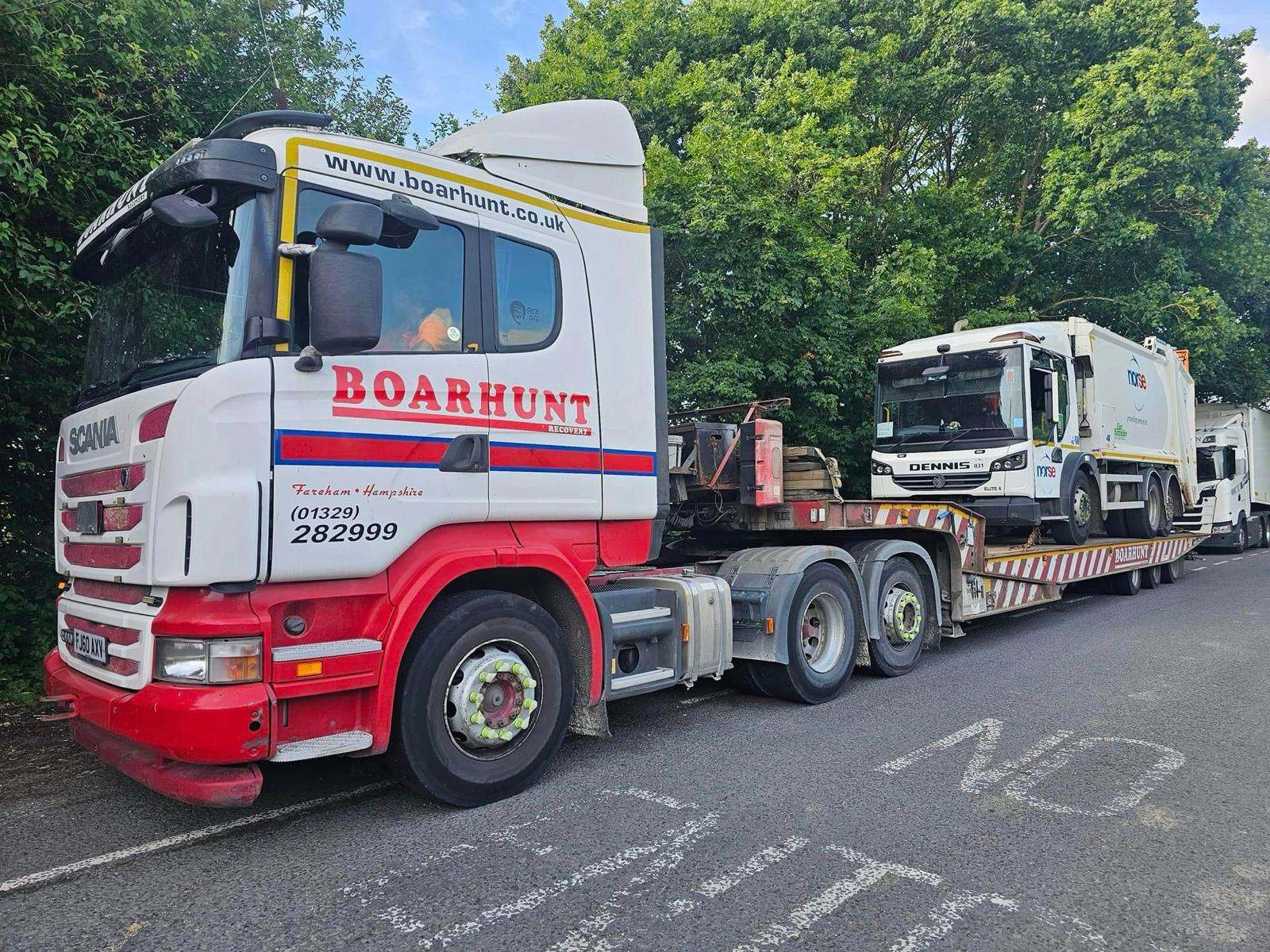 Boarhunt branded truck lifting a tractor