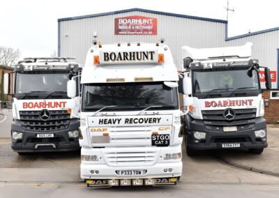three white heavy trucks side by side