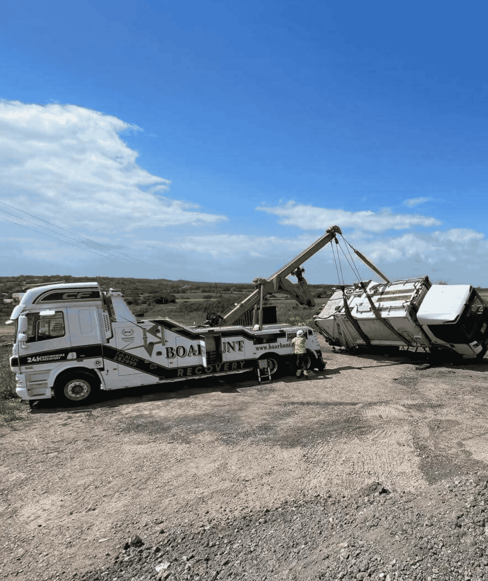 Boarhunt branded truck lifting a tractor