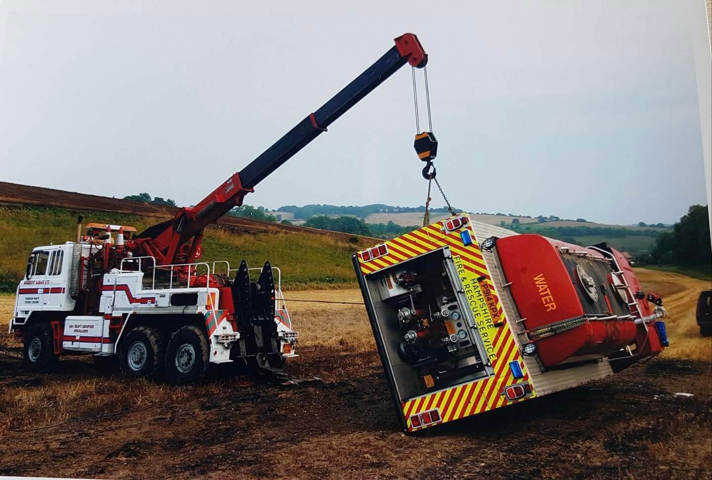 Crane lifting tractor